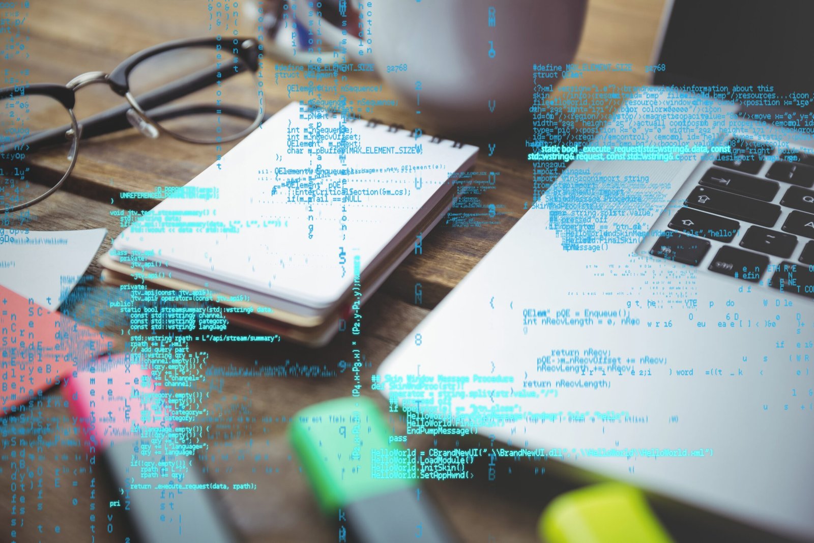 digital composite of laptop with notepad and coffee on table with graphics